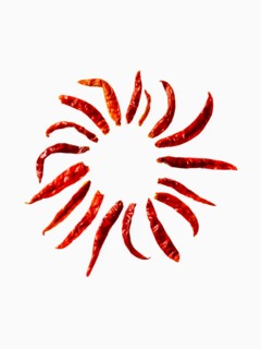 Studio shot of Red Chili Peppers on white background. Photo: David Arky