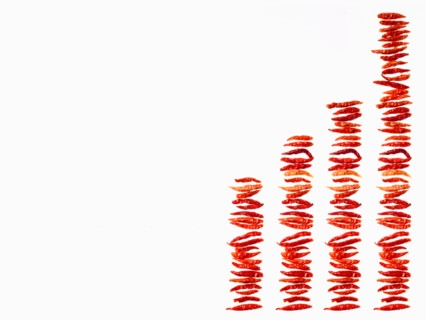 Studio shot of Red Chili Peppers on white background. Photo : David Arky