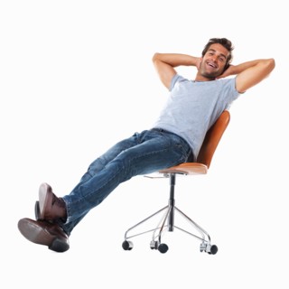 Studio shot of young man relaxing on chair. Photo : momentimages