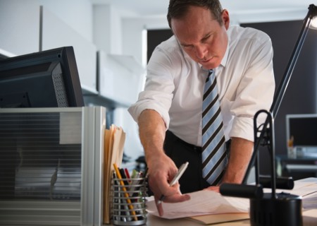 Businessman working in office. Photo : Jamie Grill