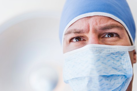 Male surgeon wearing surgical mask.