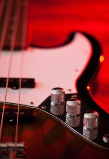 Close up of volume knobs of bass guitar. Photo : Daniel Grill
