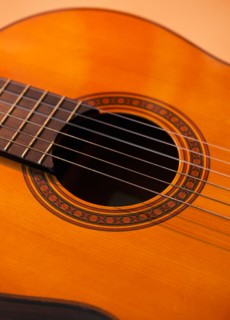 Close up of acoustic guitar. Photo : Daniel Grill