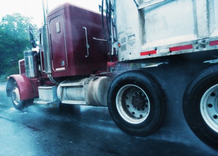 Old truck driving in rain.