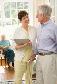 Senior man and nurse talking in nursing home.
