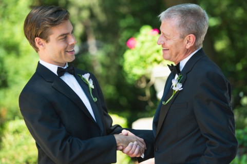 Father with bridegroom at wedding.