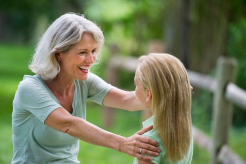 Girl (10-11) and grandmother laughing togetherness.