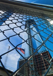 USA, New York, New York City, Lower Manhattan, Ground Zero, Freedom Tower seen through chainlink fence.