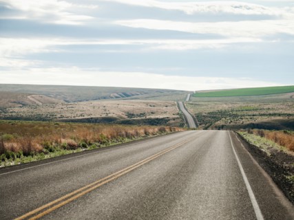 USA, Oregon, Boardman, Rolling landscape with empty road.