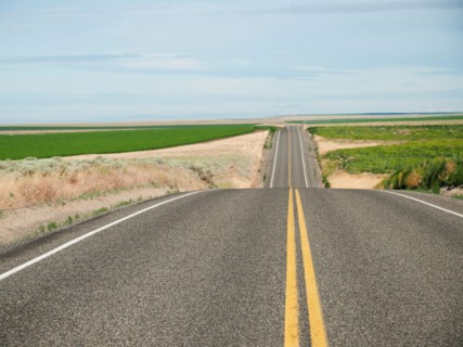 USA, Oregon, Boardman, Rolling landscape with empty road.