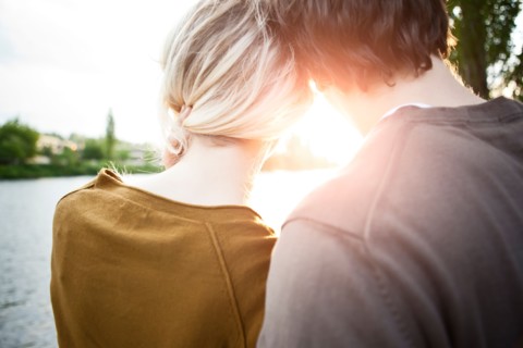 Rear view of young couple looking at sunset. Photo : Take A Pix Media