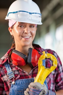 Portrait of female manual worker wearing hardhat. Photo : db2stock