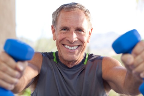 Portrait of senior man lifting dumbbells. Photo : db2stock