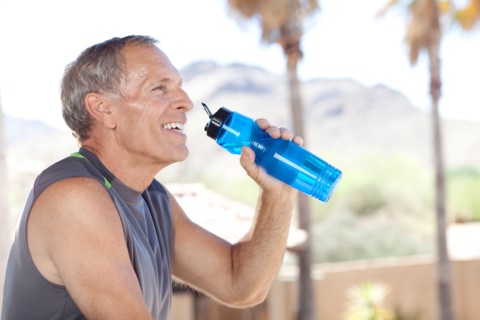 Senior man drinking water from bottle. Photo : db2stock