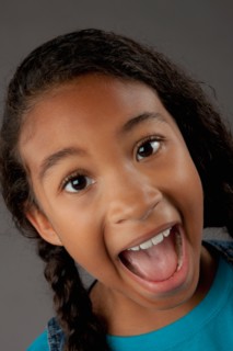 Studio portrait of girl (8-9) shouting. Photo: Rob Lewine