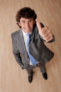Portrait of mid adult businessman with thumb up. Photo : Rob Lewine