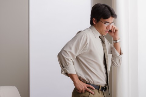 Young businessman using cell phone. Photo : Rob Lewine