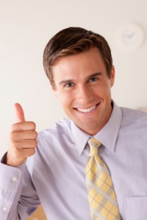 Portrait of businessman with thumbs up. Photo : Rob Lewine