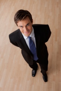 Portrait of young businessman smiling. Photo : Rob Lewine