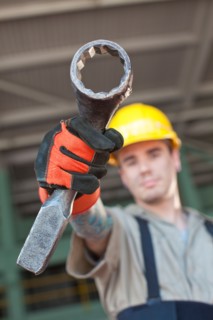 Portrait of male manual worker holding tool. Photo : db2stock