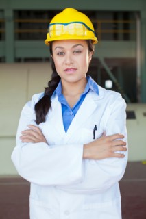 Portrait of woman wearing lab coat and hardhat. Photo : db2stock