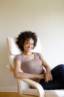 Portrait of young woman sitting in armchair. Photo: Rob Lewine