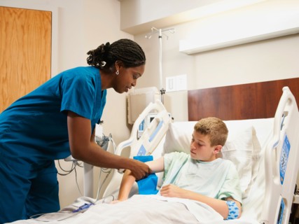 Nurse checking blood pressure to boy (10-11). Photo: Erik Isakson