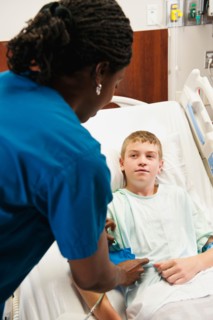 Nurse checking blood pressure to boy (10-11). Photo: Erik Isakson