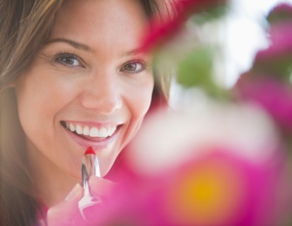 Close up of smiling woman with lipstick. Photo : Jamie Grill
