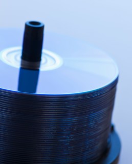 Stack of CDs, studio shot. Photo : Daniel Grill