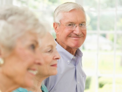 Profiles of senior women and senior man, focus on man.