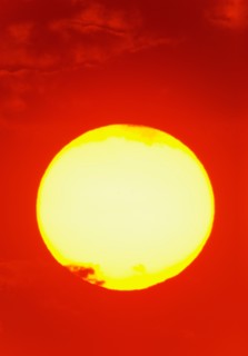 Close-up of large red sun.