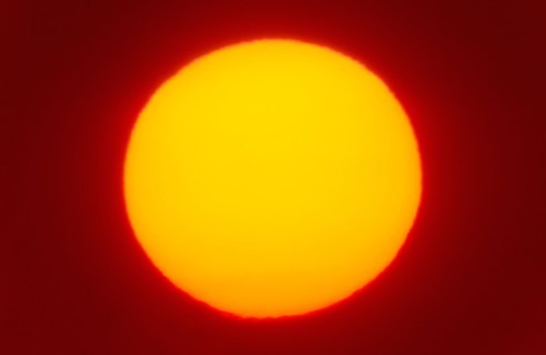 Close-up of large red sun.