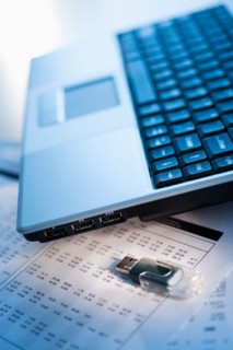 Studio shot of laptop with memory stick.