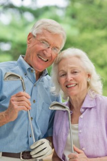 Senior couple playing golf.