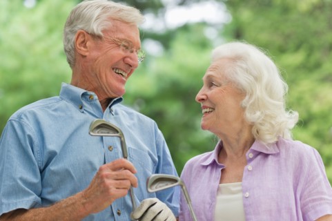 Senior couple playing golf.
