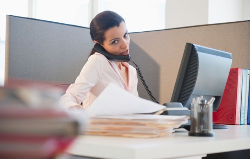 Businesswoman working at desk in office. Photo : Jamie Grill