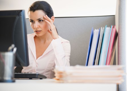 Businesswoman working at desk in office. Photo : Jamie Grill