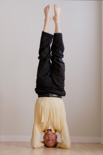 Mature businessman doing headstand. Photo: Rob Lewine