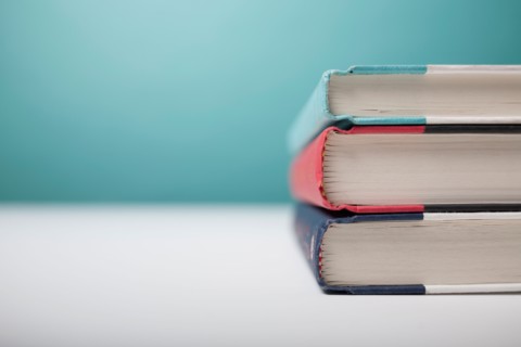 Studio shot of three books in stack. Photo : Winslow Productions