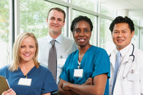 Doctor, hospital manager and two nurses posing for portrait.