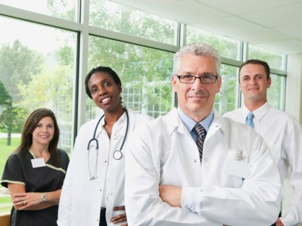 Male and female doctor, hospital manager and nurse posing for portrait.