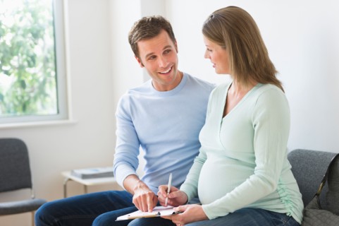 Young couple in doctor's waiting room.