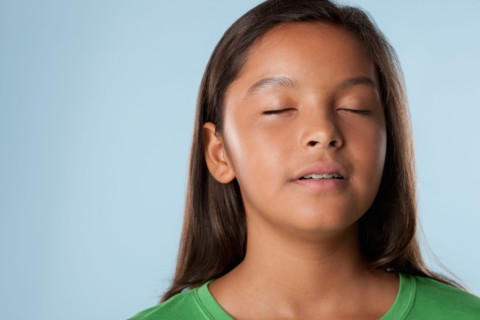 Studio portrait of girl (10-11) with closed eyes. Photo : Rob Lewine