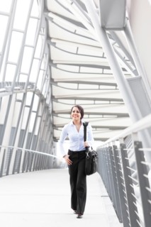 Young businesswoman on walkway. Photo: Take A Pix Media