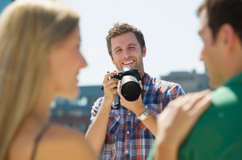Photographer taking picture of couple.