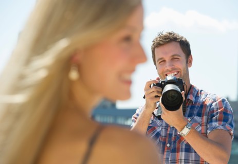 Photographer taking picture of woman.