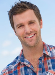 Portrait of mid adult man against blue sky.