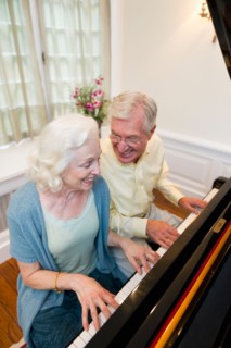 Senior couple playing piano.