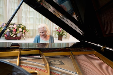Senior woman playing piano.